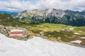 Red and white marking of the hiking trail in the Austrian Alps. Sunny mountain panorama with snow, Austria