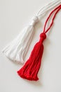 Red and white Martisor, Martenitsa tassel symbolizing springs arrival on white isolated background. Traditional Moldavian,