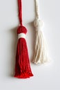 Red and white Martisor, Martenitsa tassel symbolizing springs arrival on white isolated background. Traditional Moldavian,