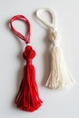 Red and white Martisor, Martenitsa tassel symbolizing springs arrival on white isolated background. Traditional Moldavian,