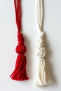 Red and white Martisor, Martenitsa tassel symbolizing springs arrival on white isolated background. Traditional Moldavian,