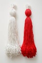 Red and white Martisor, Martenitsa tassel symbolizing springs arrival on white isolated background. Traditional Moldavian,