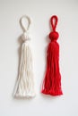 Red and white Martisor, Martenitsa tassel symbolizing springs arrival on white isolated background. Traditional Moldavian,