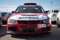 Red white Mitsubishi Lancer Evolution IX parked at an exhibition