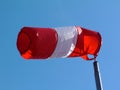 Red and white nylon textile tube windsock blown by the wind Royalty Free Stock Photo