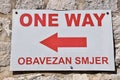 Red and White One Way sign with arrow pointing left. From Dubrovnic Old Town, Croatia. Royalty Free Stock Photo