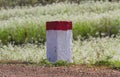 Red and white painted milestones
