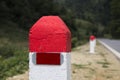 Red and white painted milestones