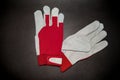 Red and white pair of leather work gloves