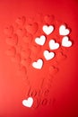 Red and white paper background, cut out hearts are lined up in the shape of a balloon. Words I love you. Royalty Free Stock Photo