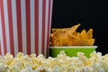 A red and white paper cup and a container of nachos on popcorn Royalty Free Stock Photo