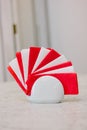 Red and white paper napkins in ceramic holder on table. Royalty Free Stock Photo