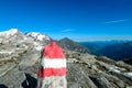 Red white path mark on a rock with view on Hoher Sonnblick in the Hohe Tauern Alps in Carinthia, Austria, Europe. Rock formations