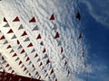 Red and white pennant triangle flag with sky background