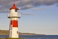 Red and white picturesque lighthouse. Faroe islands, Torshavn harbor