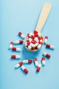 Red and white pill capsules on a blue background. Royalty Free Stock Photo