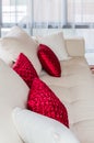 Red and white pillow on modern white sofa at home Royalty Free Stock Photo