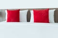 Red and white pillows on a bed