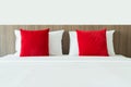 Red and white pillows on a bed