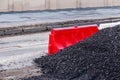 Red barrier and mountain rubble on the street