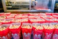 red and white popcorn bags lined up with machine in background Royalty Free Stock Photo