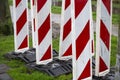 Red & white reflective roadblock barricades for directing traffic during roadwork or maintenance in a construction zone. Concept