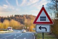 A red and white road sign. Attention, if you turn left, you are approaching a railway crossing. Royalty Free Stock Photo