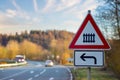 A red and white road sign. Attention, if you turn left, you are approaching a railway crossing. Royalty Free Stock Photo