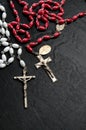 Red and White Rosary with Catholic Cross on Black Background Royalty Free Stock Photo