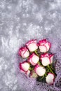 Red white rose flower bouquet on stone table. Royalty Free Stock Photo