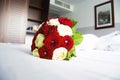 Red and White Roses Bouquet on a Bed