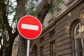 Red and white round stop sign on the street in the city street, summer time Royalty Free Stock Photo