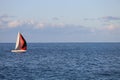 Red and white sailing boat on blue sea Royalty Free Stock Photo