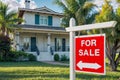 A red and white for sale sign in front in front of a private house Royalty Free Stock Photo