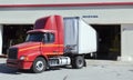 Delivery truck backing into warehouse bay