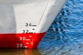 Red and white ship hull with waterline and draft scale measure Royalty Free Stock Photo