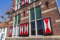 Red and white shutters on a historic house in Meppel