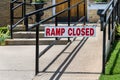 Red and white sign saying ramp closed