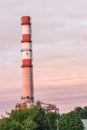 Red and white smoke stack chimney at a factory in Riga, Latvia Royalty Free Stock Photo