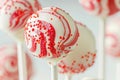 Red and White Sprinkled Cake Pop on a White Background