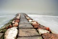 Red and white stone pier in the mist Royalty Free Stock Photo