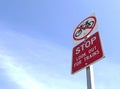 Red and white Stop, Look Out For Trains sign in a bright blue sky Royalty Free Stock Photo