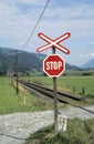 Red and white stop sign for people at railway crossing Royalty Free Stock Photo