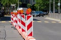 Red and white street barriers with flashlight to secure a construction site, roadworks, road under construction. Temporary fencing Royalty Free Stock Photo