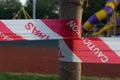 Red and white strip plastic barricade barrier with Awas and Caution word