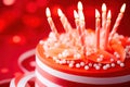 a red and white striped cake with lit candles Royalty Free Stock Photo