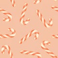 Red and white striped candy canes on a pink background. Christmas seamless pattern with candy canes Royalty Free Stock Photo