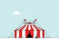 Red and white striped circus tent set against a pale blue sky. The tent features multiple red flags Royalty Free Stock Photo