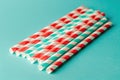 Red and white striped drinking straws on a teal background Royalty Free Stock Photo