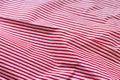 Red and white striped fabric texture. Crumpled bright colored cotton background. Selective focus. Closeup view Royalty Free Stock Photo